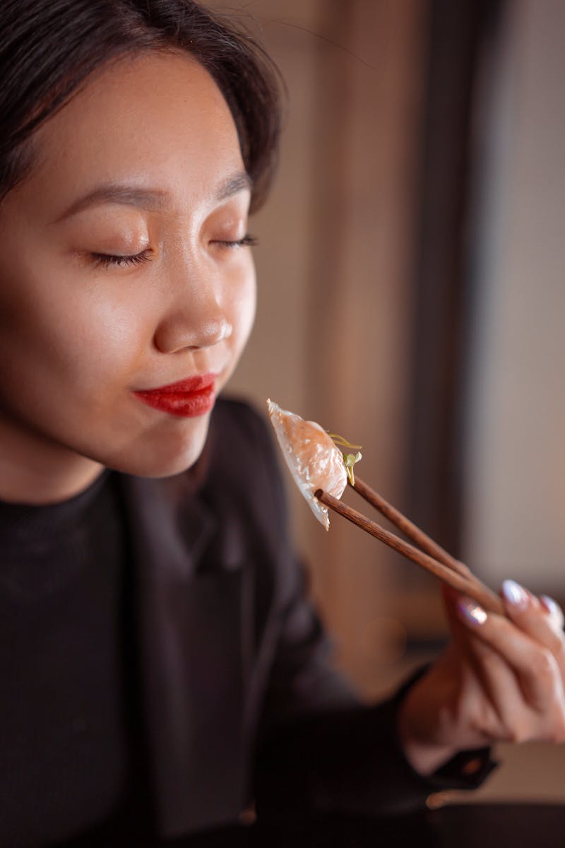 woman taking a micro moment to taste food with chopsticks