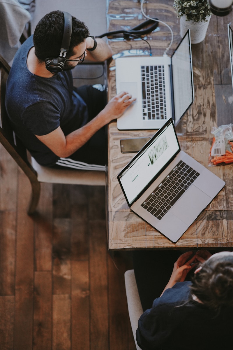 man taking brief pause to sound on computer through headphones