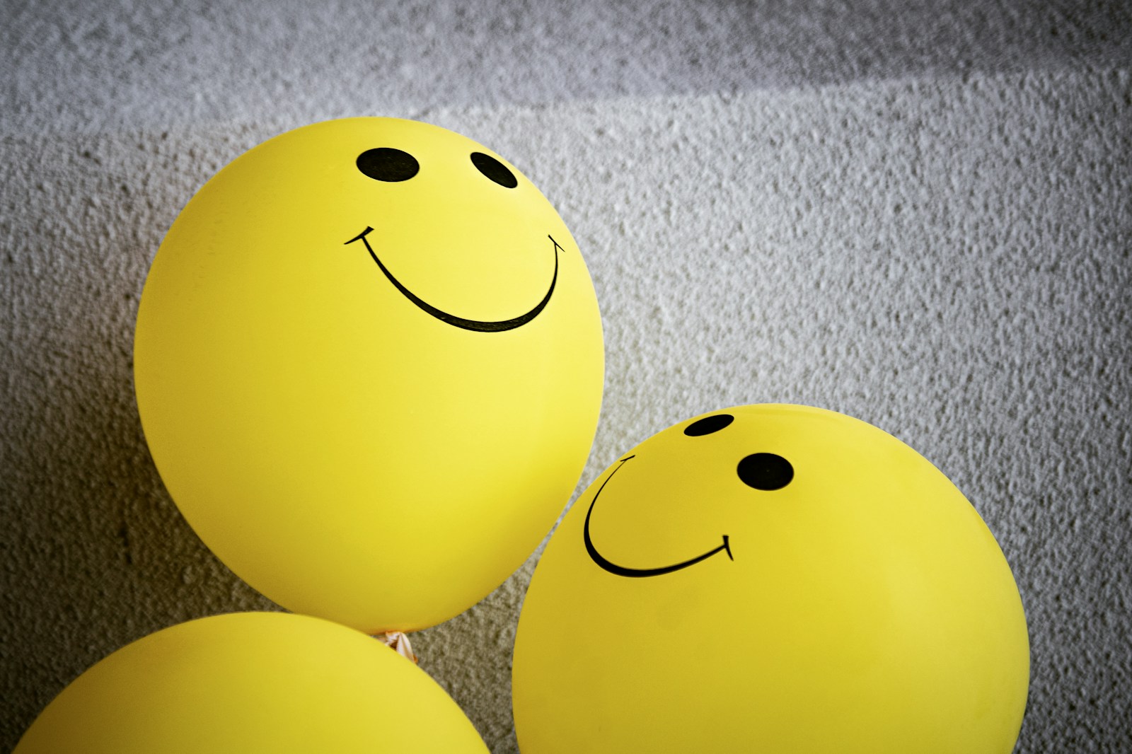yellow smiley emoji balloons to show startup wellbeing.