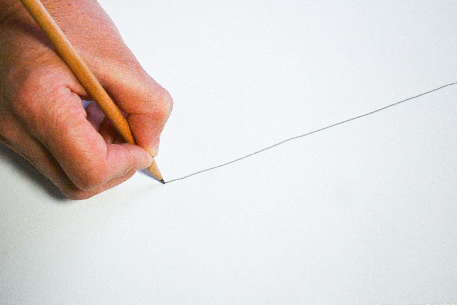 Boundaries beneficial for wellbeing shown by line drawn on paper with a pencil.