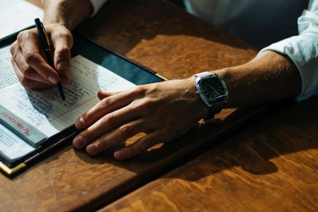 startup writing on paper leaning on brown table