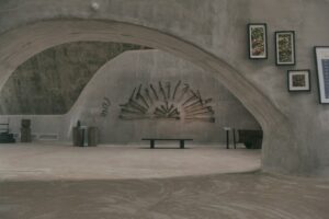 loneliness at the top in an echo chamber of concrete with woodbench