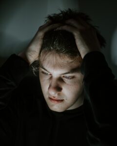 woman in black long sleeve shirt having trouble concentrating