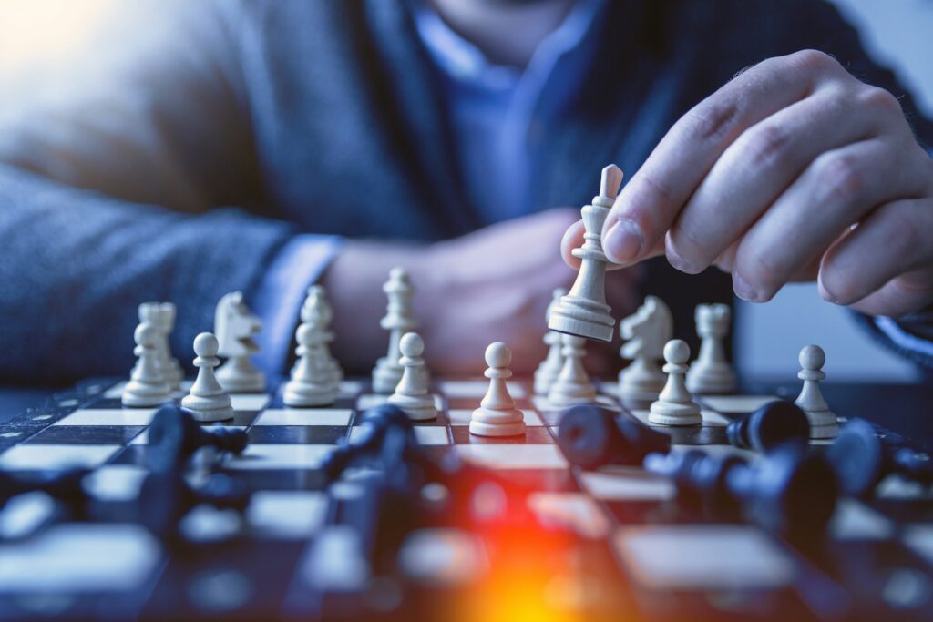 man playing chess showing board leadership behaviour