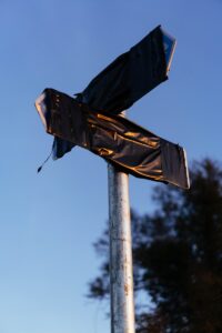 decision making point at two directional signs covered in dark tape