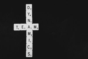 scrabble letters spelling team and dynamics related to leadership