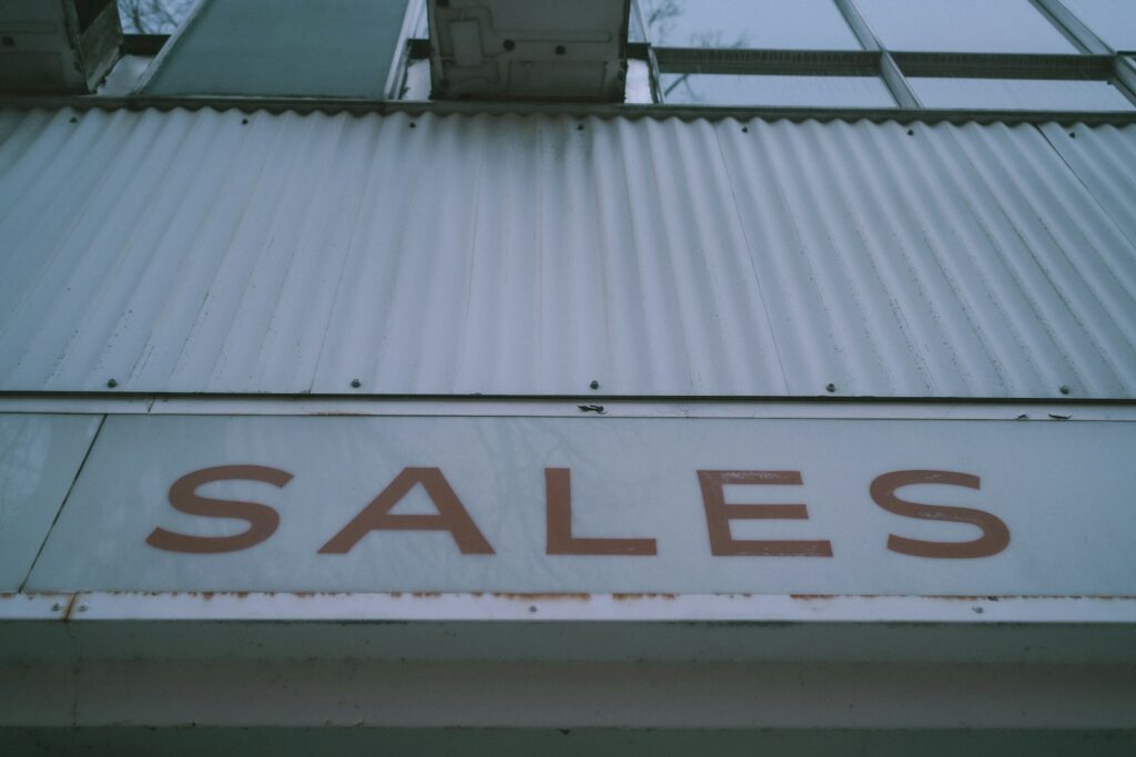Sales in red letters on white background on building 